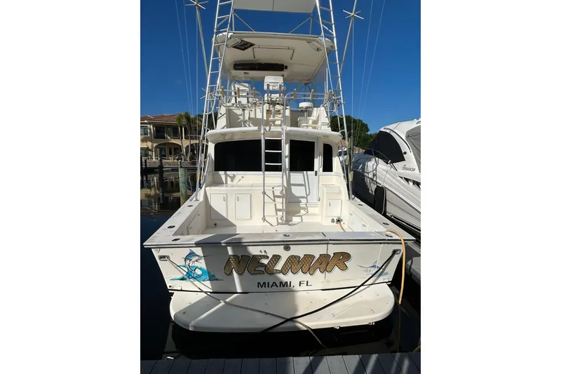 Slide: The Image of 1988 Ocean Yachts 48 Super Sport docked, rear view, with fishing tower and Miami, FL signage. - 1