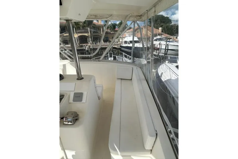 Slide: The Image of 1988 Ocean Yachts 48 Super Sport interior with white seating and marina view. - 15