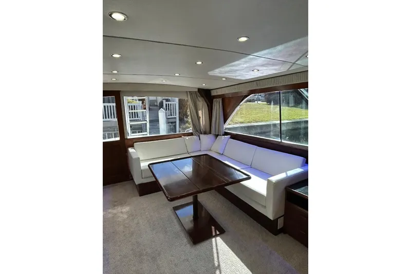 Slide: The Image of Luxurious interior of 1988 Ocean Yachts 48 Super Sport with elegant seating and table. - 7