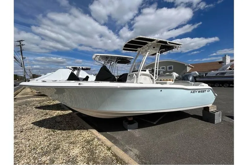 Slide: The Image of 2024 Key West 203 FS boat displayed outdoors under a partly cloudy sky. - 9