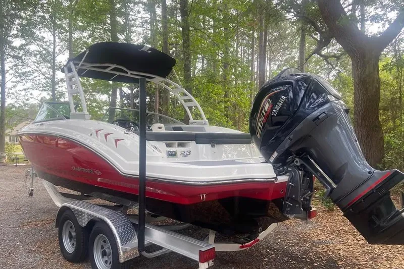 Slide: The Image of 2023 Chaparral 23 SSi OB boat on trailer in wooded area. - 1