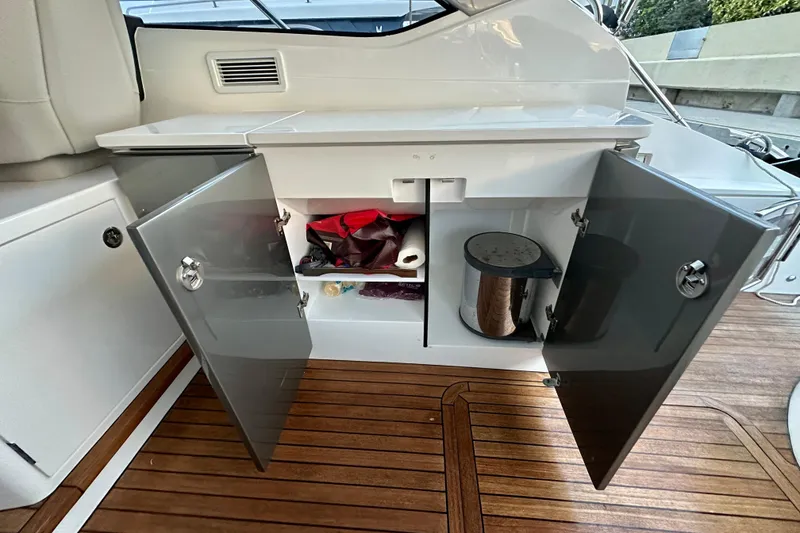 Slide: The Image of Luxurious 2021 Princess V40 yacht with elegant seating and wooden table on open water. - 11