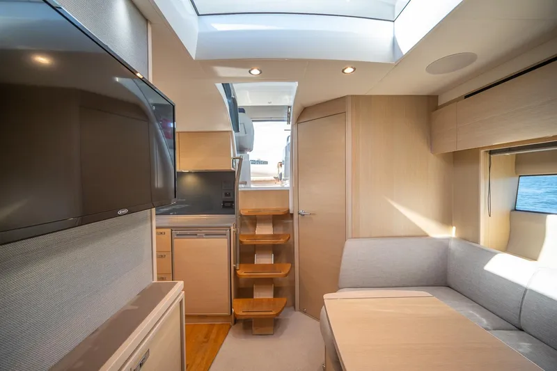 Slide: The Image of Interior of 2021 Princess V40 yacht with modern design, skylight, and cozy seating area. - 24