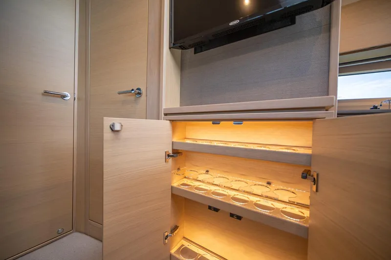 Slide: The Image of Interior of 2021 Princess V40 yacht with illuminated wooden storage cabinet. - 32