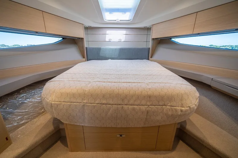 Slide: The Image of Luxurious interior cabin of 2021 Princess V40 yacht with elegant bedding and wood finishes. - 34