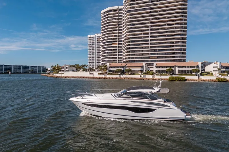 Slide: The Image of Luxury 2021 Princess V40 yacht cruising near waterfront high-rise buildings. - 47