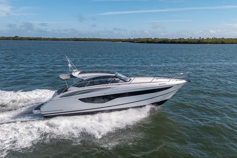 Slide: The Image of 2021 Princess V40 yacht cruising on open water under a clear blue sky. - 49