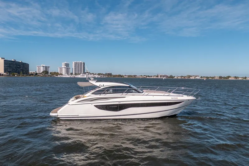 Slide: The Image of 2021 Princess V40 yacht cruising on a sunny day near city skyline. - 54