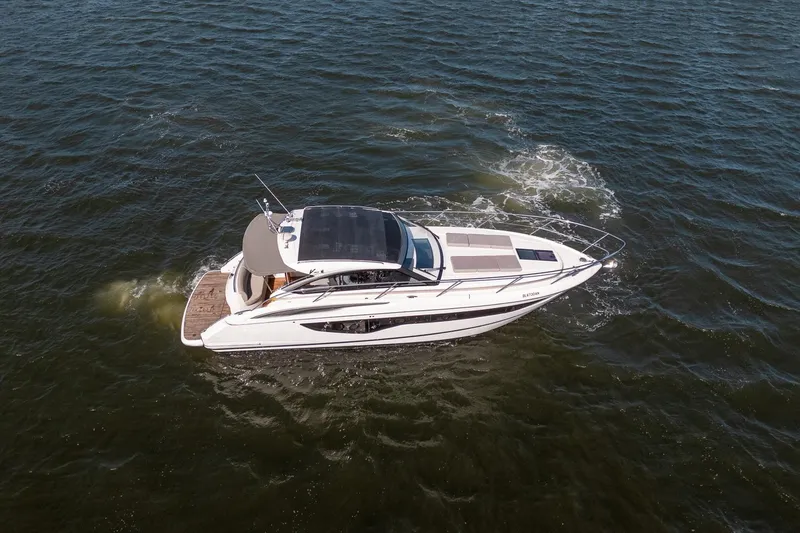 Slide: The Image of 2021 Princess V40 yacht cruising on open water, aerial view. - 55