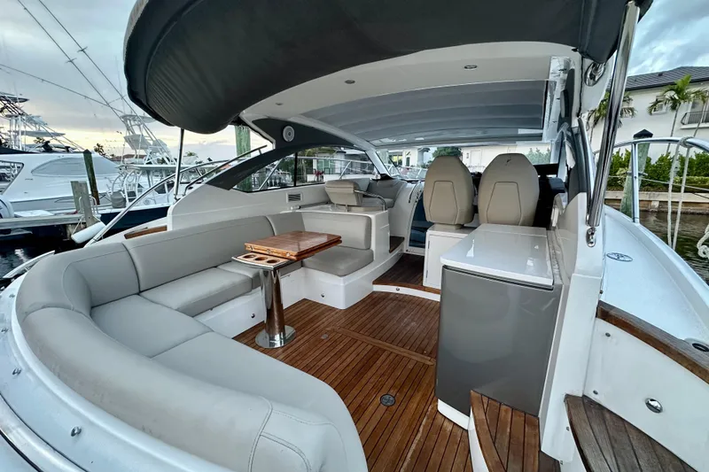 Slide: The Image of Luxury 2021 Princess V40 yacht interior with seating, table, and waterfront view. - 7