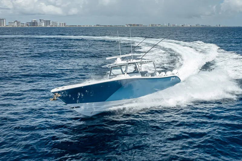 The Image of 2025 Yellowfin 42 Offshore boat cruising on open ocean with city skyline in background. - 0