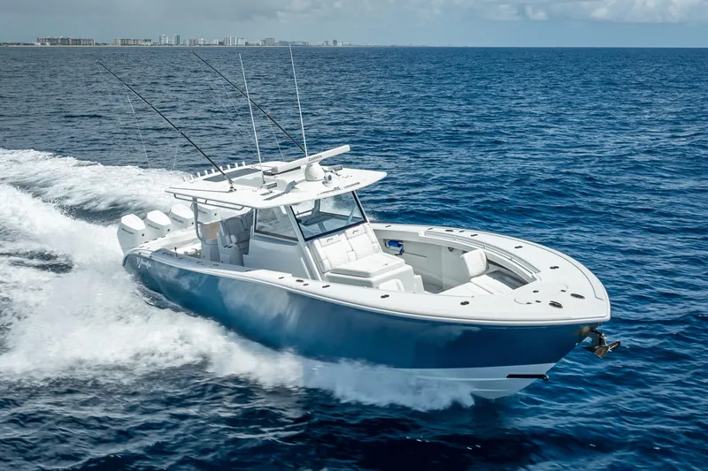Slide: The Image of 2025 Yellowfin 42 Offshore boat cruising on open ocean waters. - 10