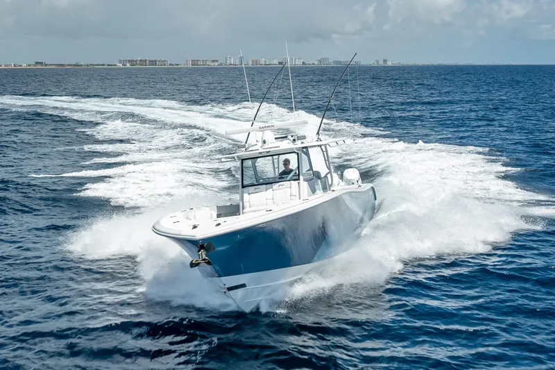 Slide: The Image of 2025 Yellowfin 42 Offshore boat cruising on open ocean waters. - 11