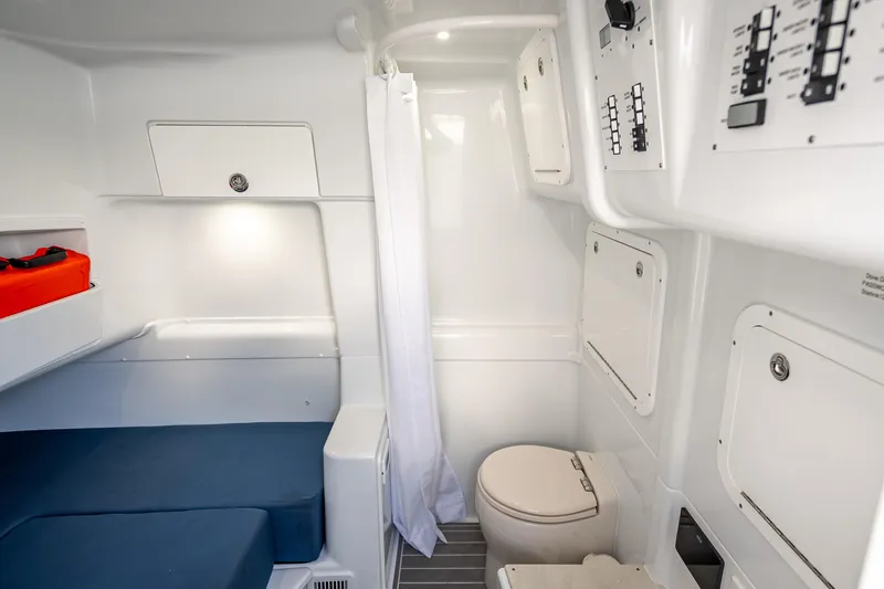 Slide: The Image of 2025 Yellowfin 42 Offshore cabin interior with bed, toilet, and storage compartments. - 14