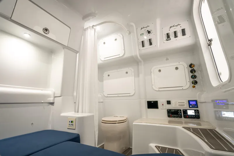 Slide: The Image of 2025 Yellowfin 42 Offshore cabin interior with modern amenities and control panels. - 16