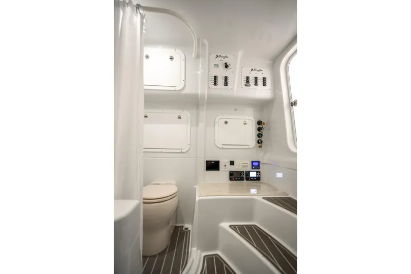 Slide: The Image of 2025 Yellowfin 42 Offshore boat interior with modern bathroom and control panels. - 17