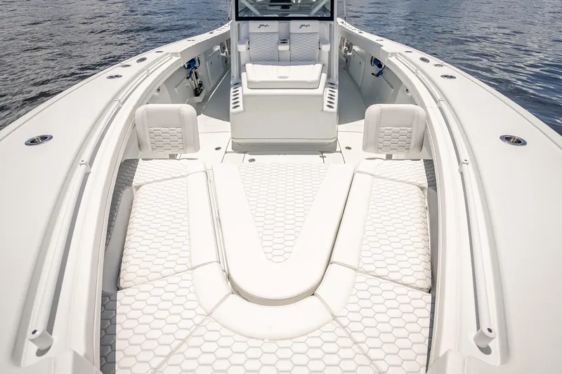Slide: The Image of 2025 Yellowfin 42 Offshore boat interior with white seating and hexagonal pattern design. - 22