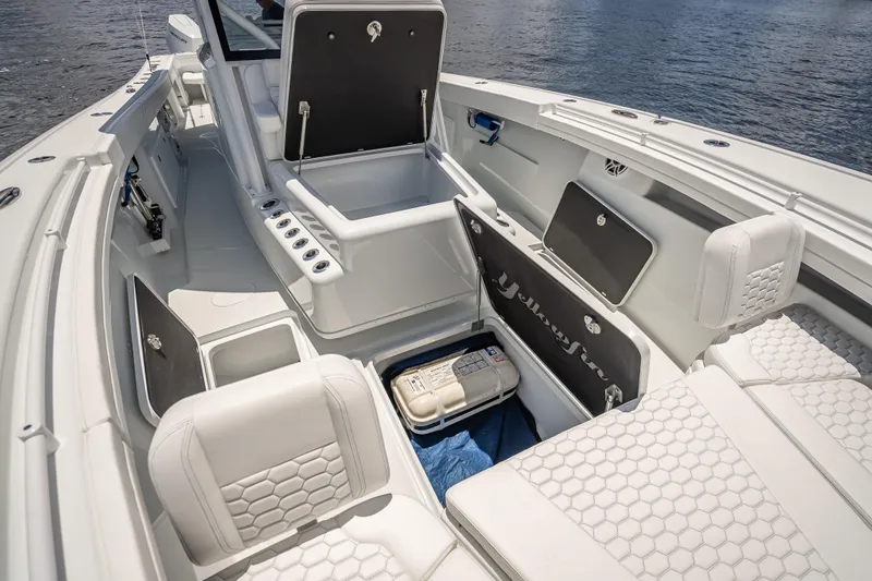 Slide: The Image of 2025 Yellowfin 42 Offshore boat interior with white seating and storage compartments. - 25