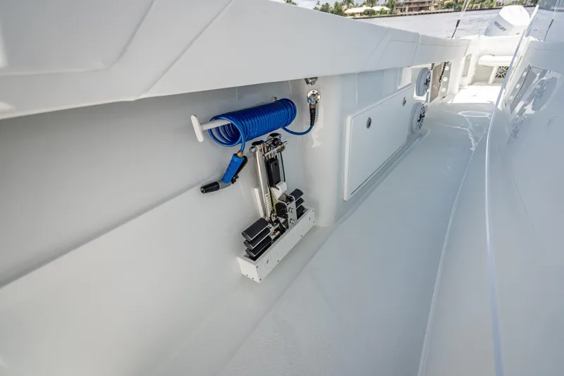 Slide: The Image of 2025 Yellowfin 42 Offshore boat deck with coiled hose and storage compartments. - 31