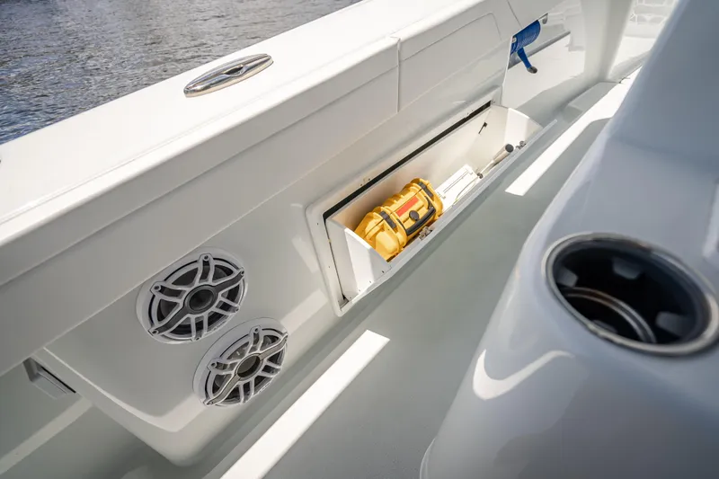 Slide: The Image of 2025 Yellowfin 42 Offshore boat interior with storage compartment and speakers. - 33
