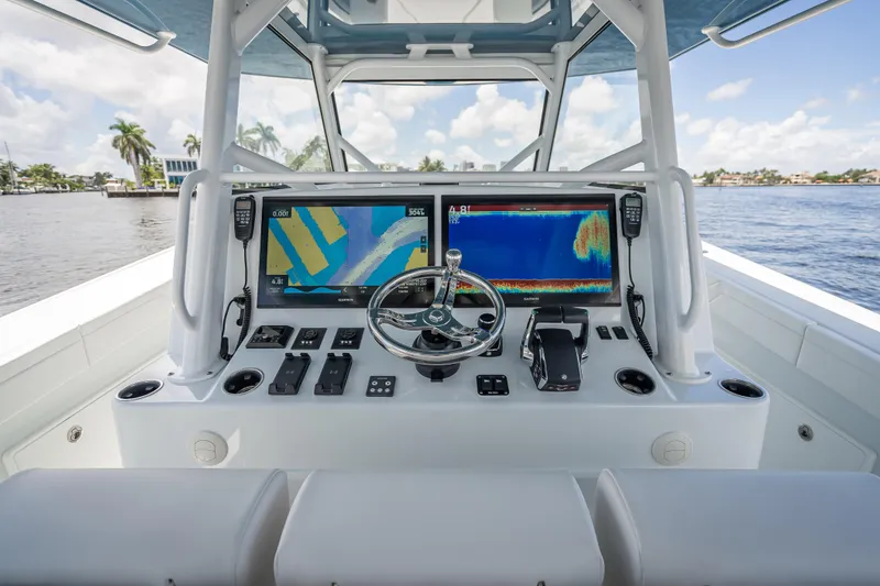 Slide: The Image of 2025 Yellowfin 42 Offshore boat dashboard with advanced navigation screens and controls. - 35