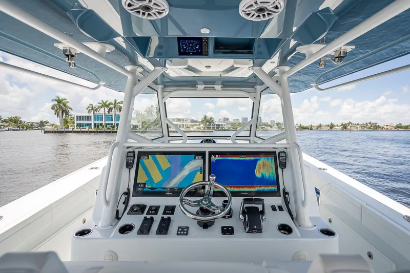 Slide: The Image of 2025 Yellowfin 42 Offshore boat cockpit with advanced navigation system on a sunny day. - 36