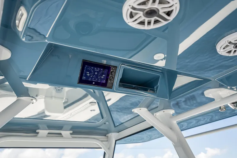 Slide: The Image of 2025 Yellowfin 42 Offshore boat interior with blue ceiling and electronic display. - 37