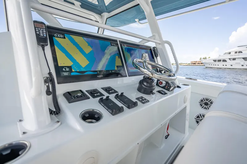 Slide: The Image of 2025 Yellowfin 42 Offshore boat dashboard with navigation screens and steering wheel. - 39