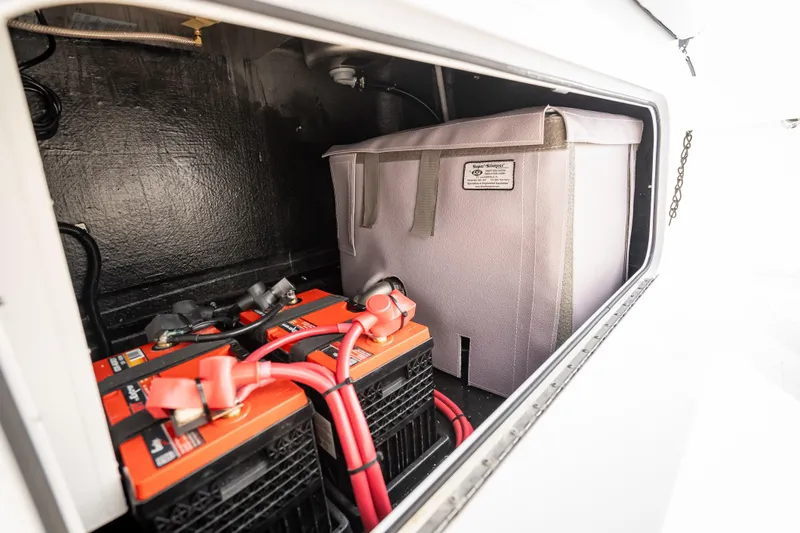 Slide: The Image of Storage compartment of 2025 Yellowfin 42 Offshore boat with batteries and equipment. - 42