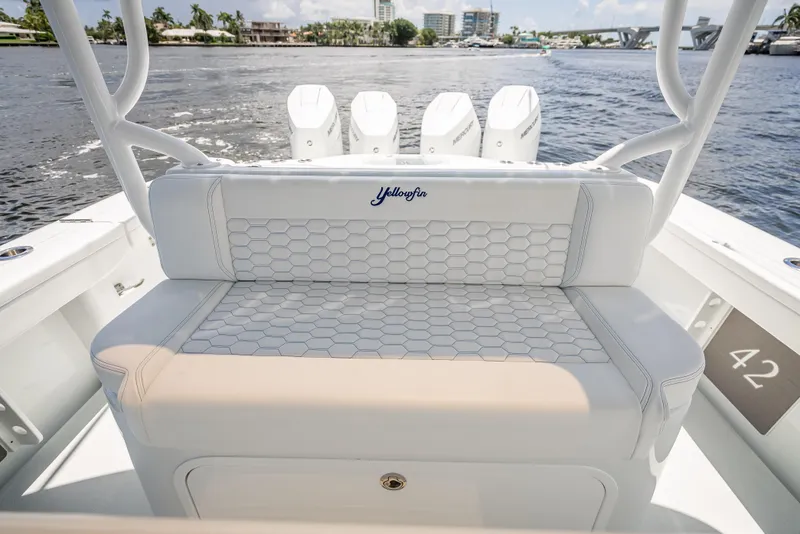 Slide: The Image of 2025 Yellowfin 42 Offshore boat interior with hexagonal-patterned seating and multiple outboard engines. - 45