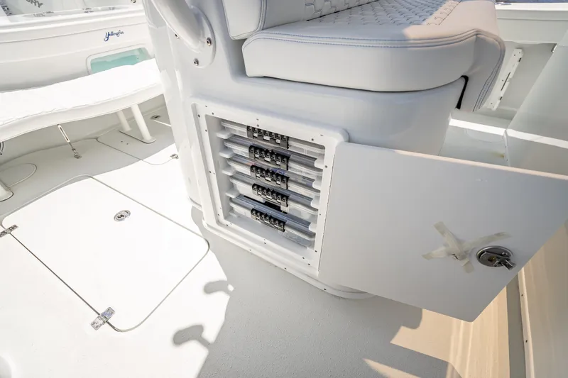 Slide: The Image of 2025 Yellowfin 42 Offshore boat interior with open storage compartment and seating. - 50