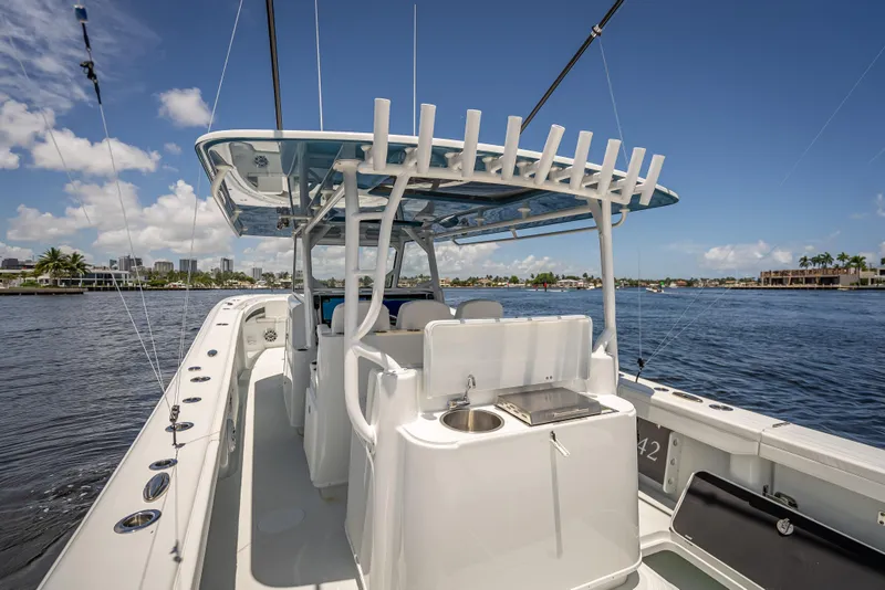 Slide: The Image of 2025 Yellowfin 42 Offshore boat with fishing rod holders and sink, cruising on a sunny day. - 58