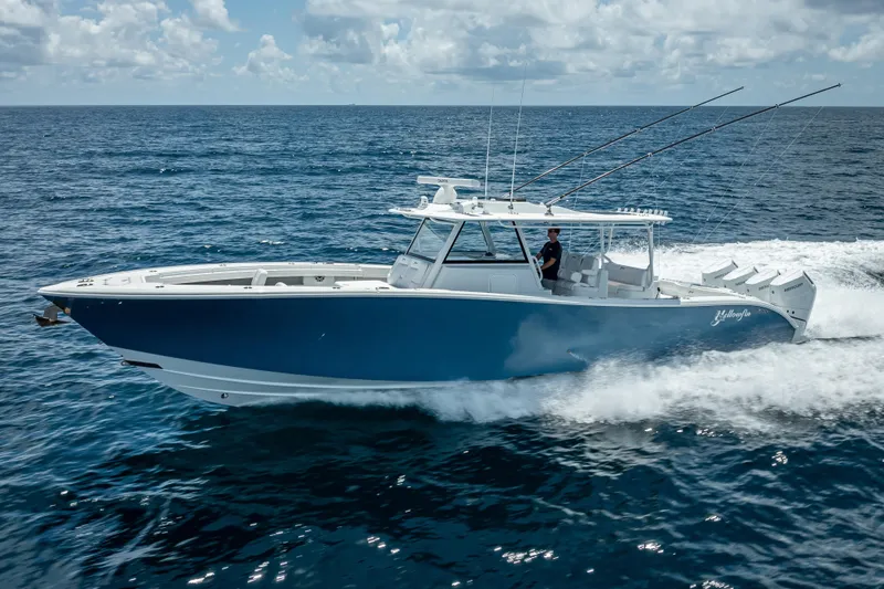 Slide: The Image of 2025 Yellowfin 42 Offshore boat cruising on open ocean under blue sky. - 8