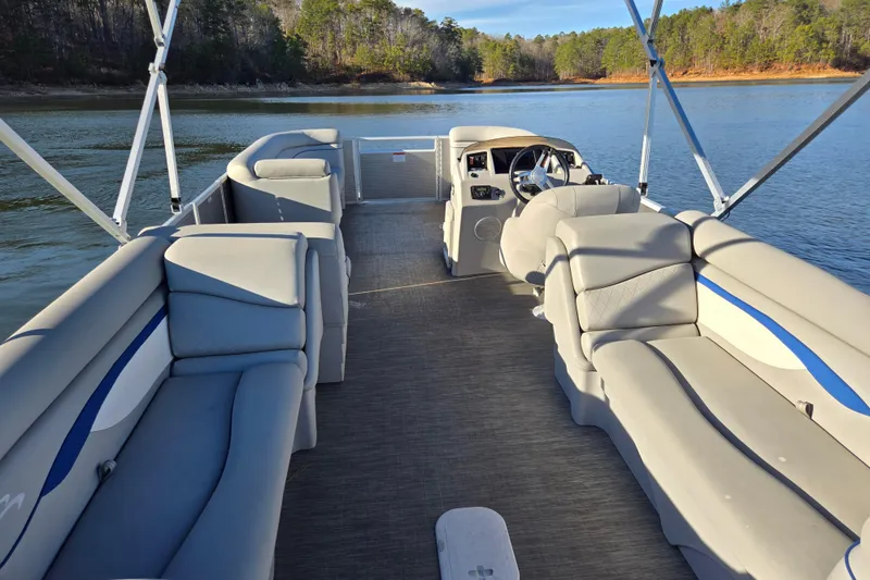 Slide: The Image of 2023 Bennington 22 SSR pontoon boat interior on a serene lake. - 12