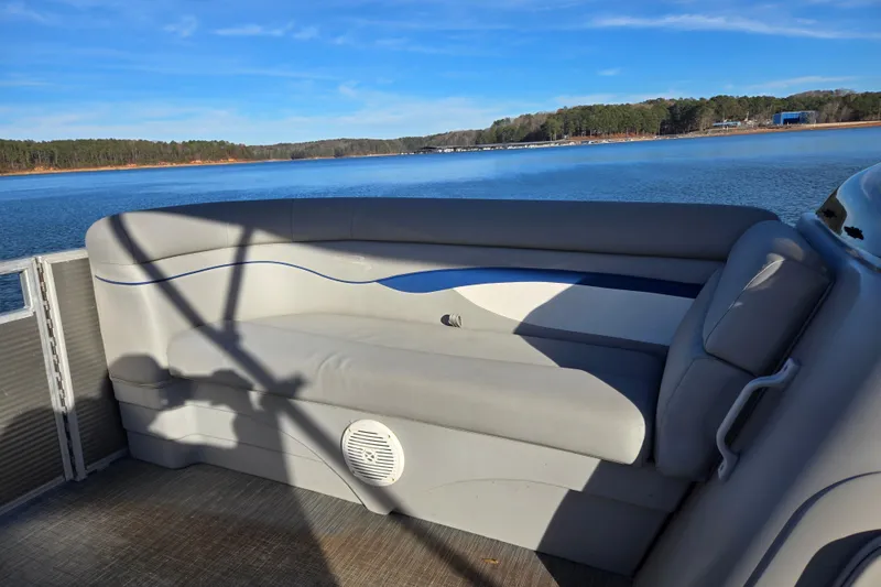Slide: The Image of 2023 Bennington 22 SSR pontoon boat interior with lake view and comfortable seating. - 14