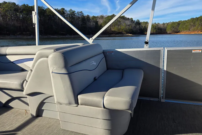 Slide: The Image of 2023 Bennington 22 SSR pontoon boat interior with lake view and comfortable seating. - 17