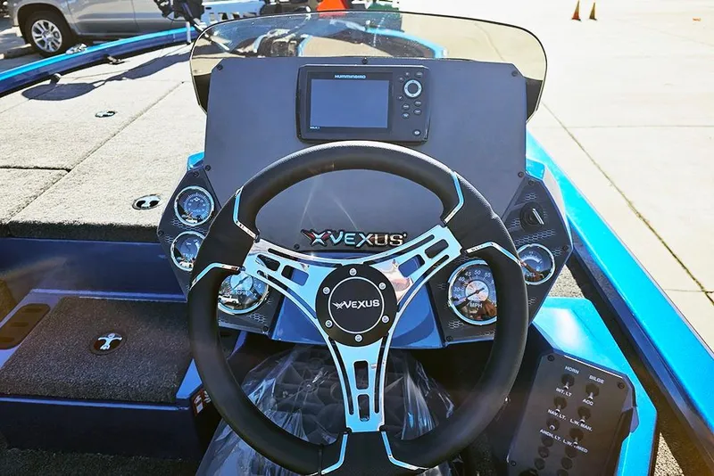 Slide: The Image of 2026 Vexus AVX1880 boat dashboard with steering wheel and navigation display. - 12