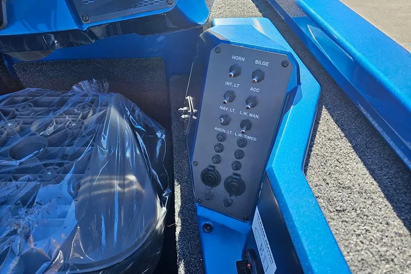 Slide: The Image of Control panel of 2026 Vexus AVX1880 boat, featuring various switches and blue interior. - 13