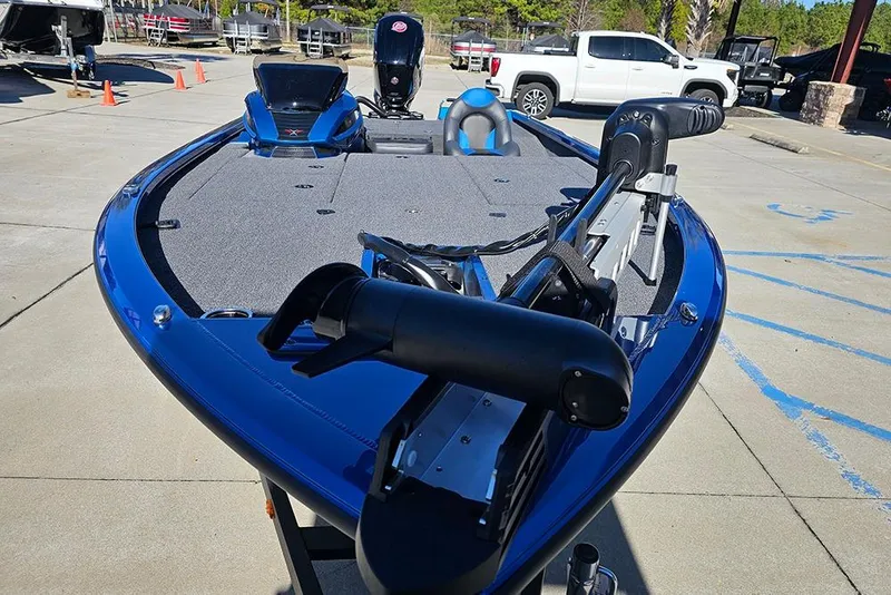 Slide: The Image of 2026 Vexus AVX1880 boat with blue trim, parked outdoors on concrete. - 4