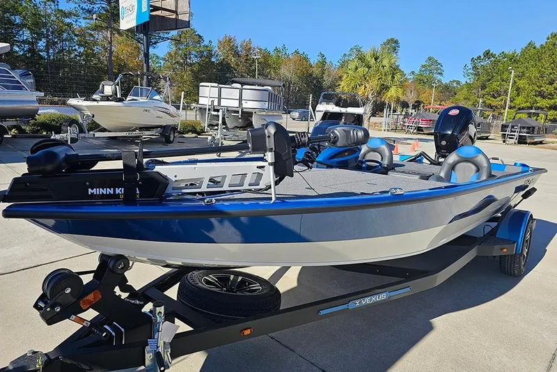 Slide: The Image of 2026 Vexus AVX1880 boat on trailer, blue and white, parked outdoors. - 5