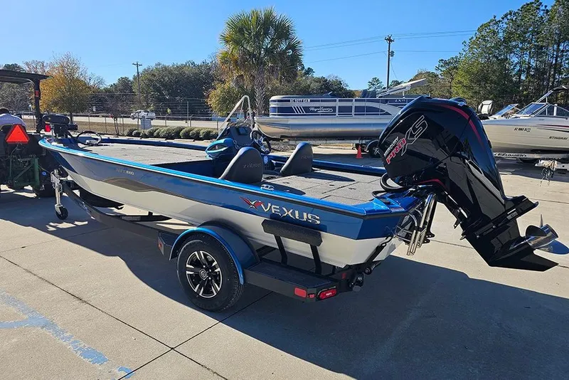 Slide: The Image of 2026 Vexus AVX1880 boat with powerful outboard motor, parked outdoors on a sunny day. - 7