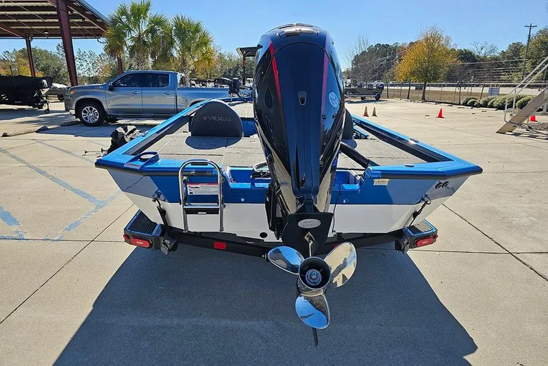 Slide: The Image of 2026 Vexus AVX1880 boat with outboard motor in a parking lot. - 8