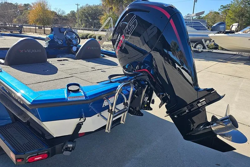 Slide: The Image of 2026 Vexus AVX1880 boat with powerful outboard motor, blue and gray design. - 9