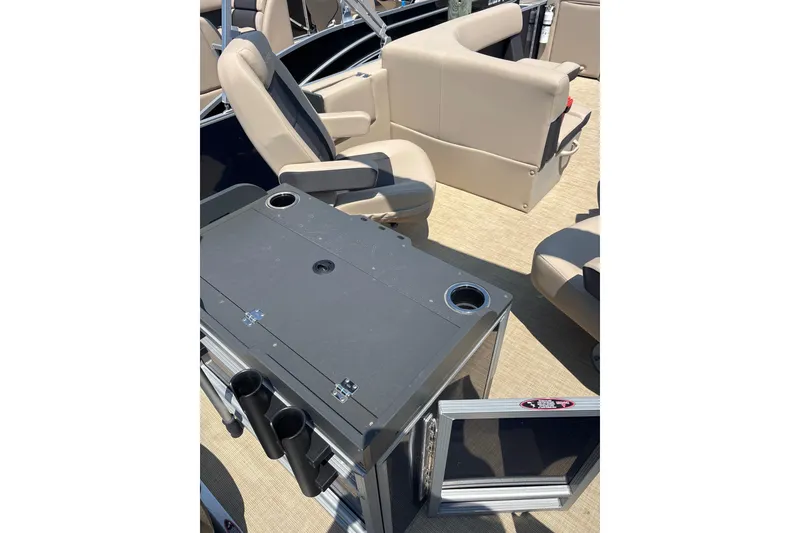 Slide: The Image of 2025 Harris Cruiser 230 interior with beige seating and a central console. - 10