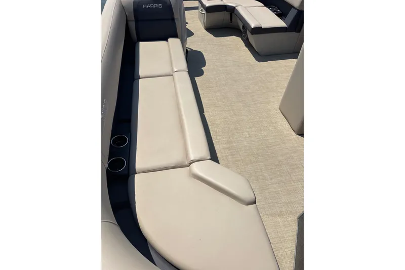 Slide: The Image of 2025 Harris Cruiser 230 interior with beige seating and cup holders. - 7
