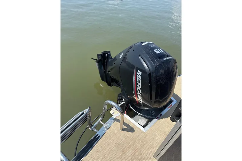 Slide: The Image of 2025 Harris Cruiser 230 with Mercury outboard motor on calm water. - 9