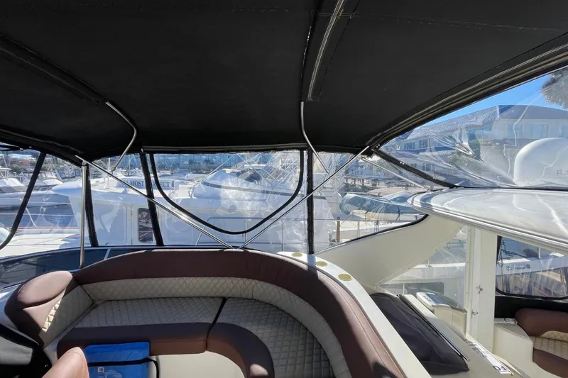 Slide: The Image of Interior view of 2004 Meridian 459 Motoryacht with seating and marina backdrop. - 13