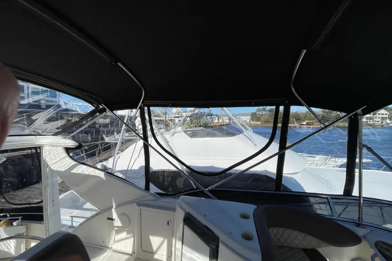 Slide: The Image of 2004 Meridian 459 Motoryacht interior view with water and marina background. - 14