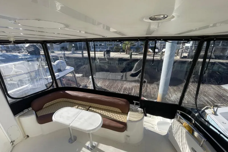 Slide: The Image of 2004 Meridian 459 Motoryacht interior with seating and table, docked at marina. - 15
