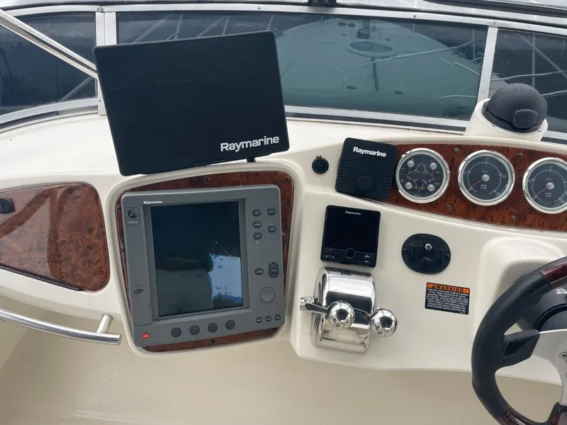 Slide: The Image of 2004 Meridian 459 Motoryacht dashboard with Raymarine navigation equipment and controls. - 17